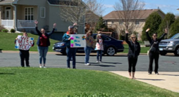 Shakopee ProAct staff members say hello to participants during a drive by home visit.