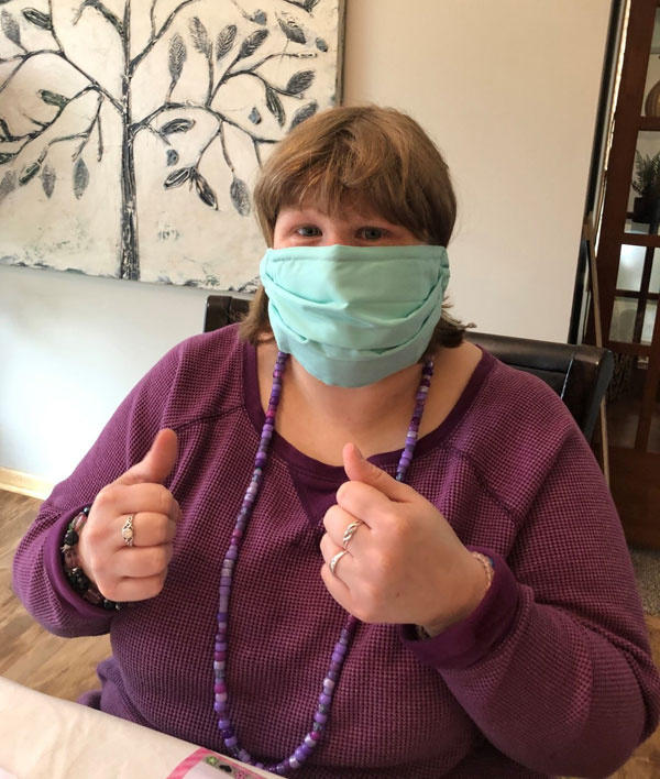 Jessica, a ProAct participant, practices wearing her mask at home.