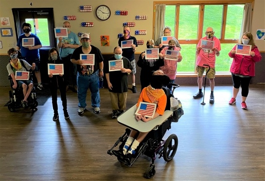 Hudson participants and staff honor vets for Memorial Day- writing to people at the Minneapolis VA Medical Center and creating flags for Fort Snelling National Cemetery