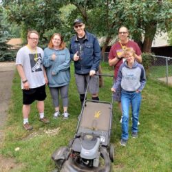 Volunteer crew rakes adopts yard