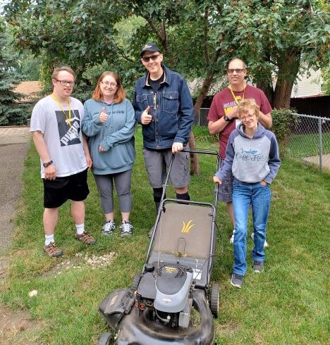 Volunteer crew rakes adopts yard